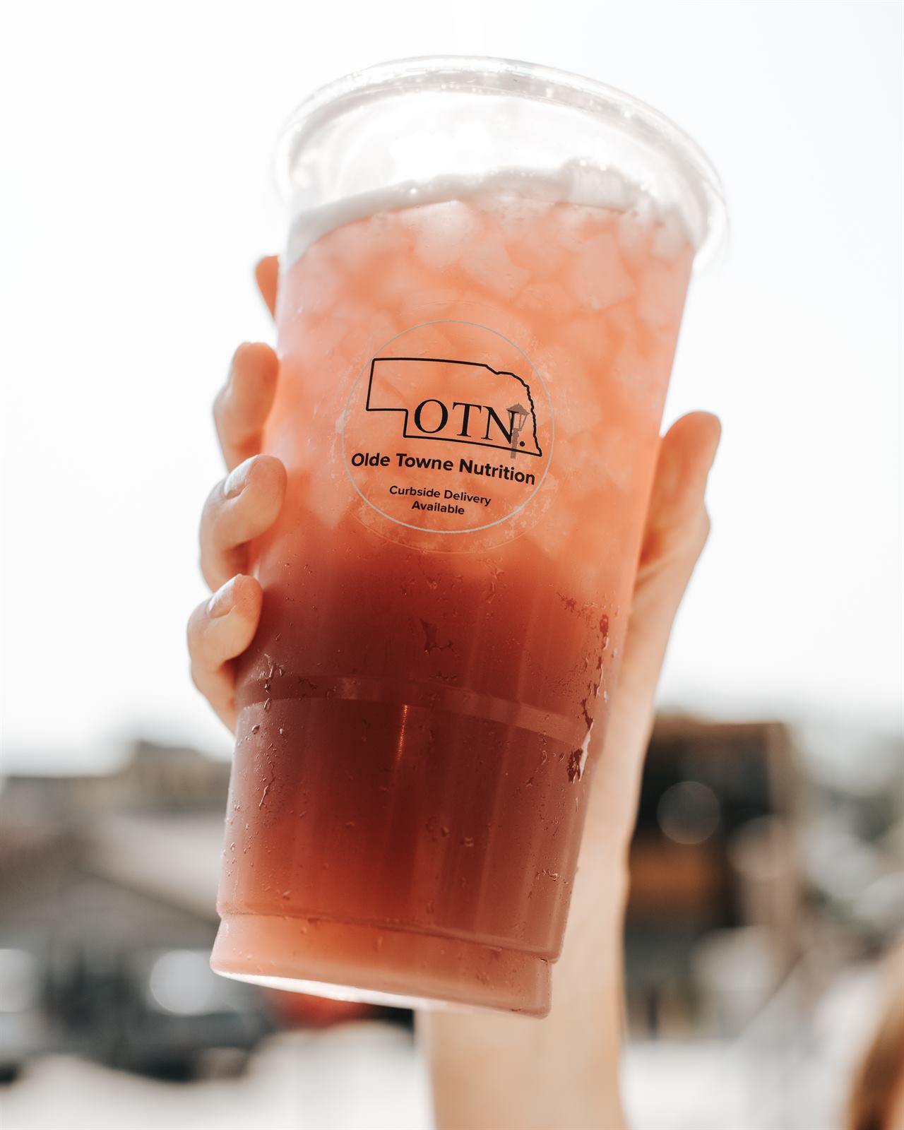 Hand holding an OTN branded loaded tea